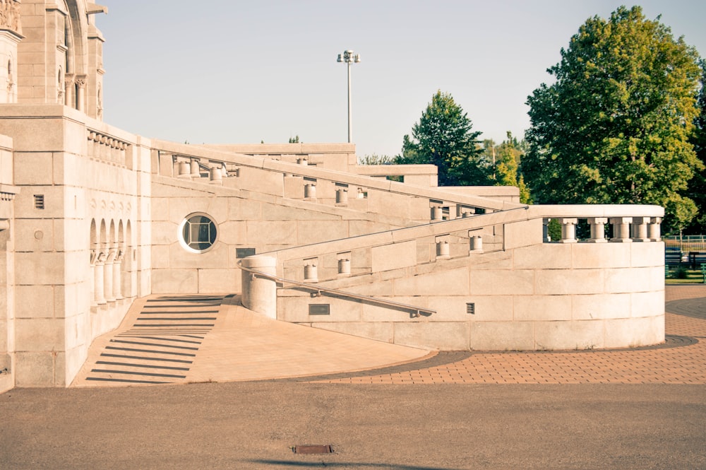 white concrete building near tree