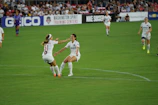 The player celebrating a key victory with teammates.