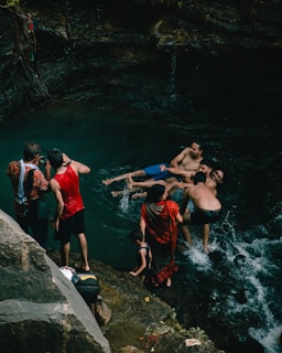 A group of happy travelers exploring the natural pools at Picãozinho