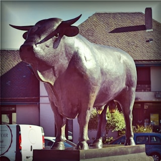 The iconic bronze bull statue standing proudly at Amsterdam's Beursplein, symbolizing financial strength and the dawn of digital trading.
