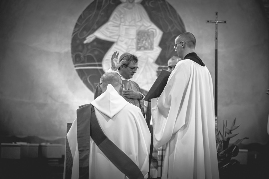 grayscale photo of 3 person inside church