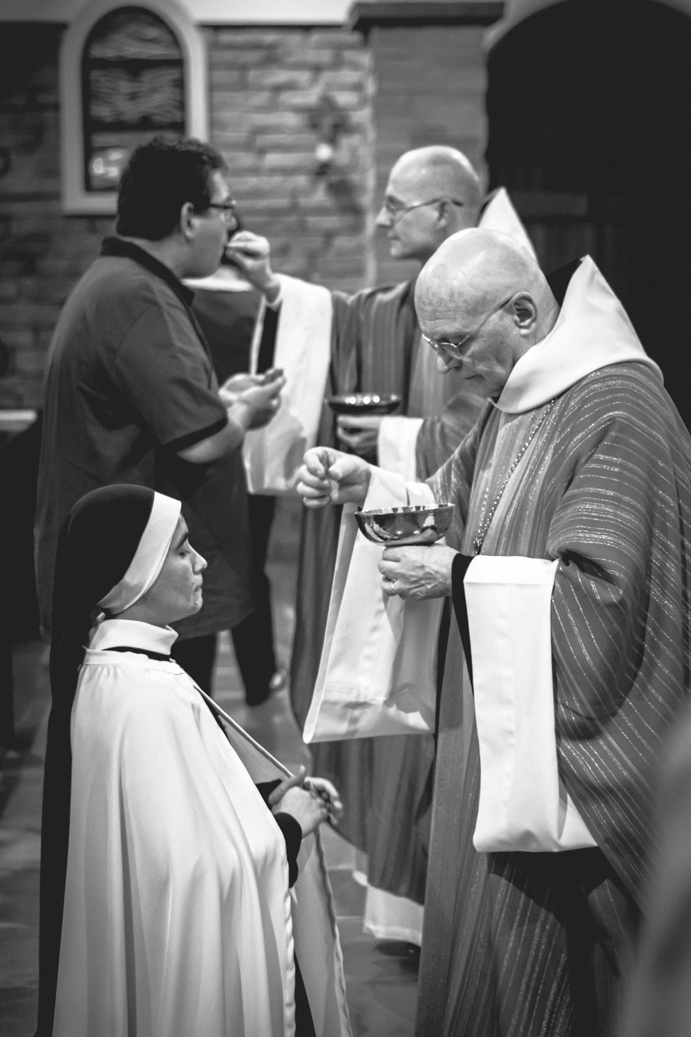 dos sacerdotes dando la Eucaristía
