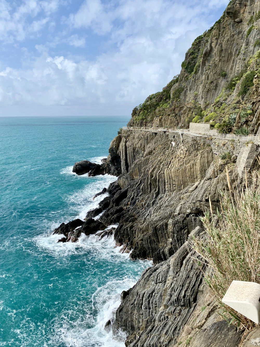 brown cliff beside ocean