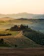 A serene horseback ride through rolling Tuscan hills at sunset.