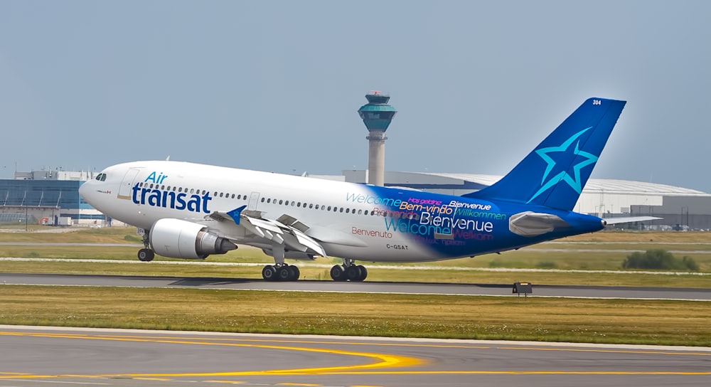 white and blue Transat airplane