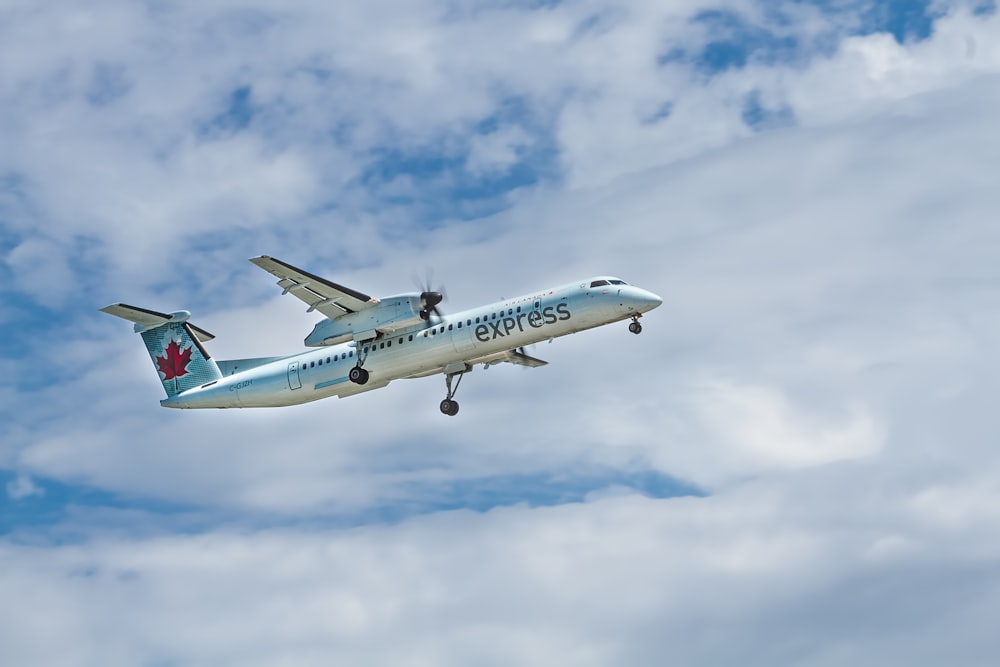 white airplane flying during daytime