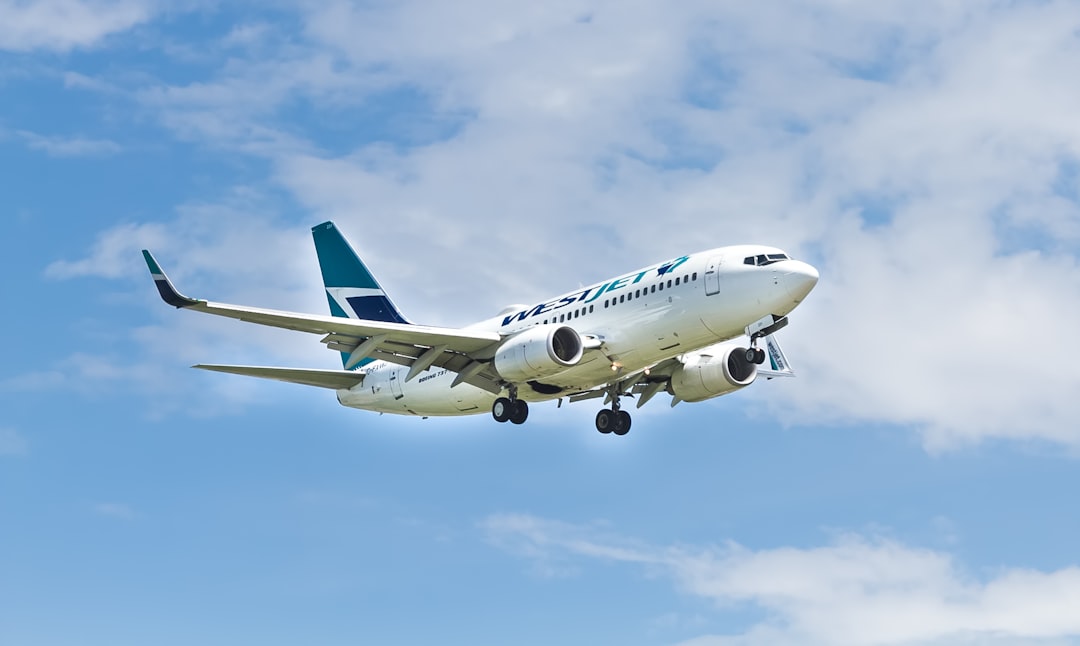 white plane, WestJet takes to the skies