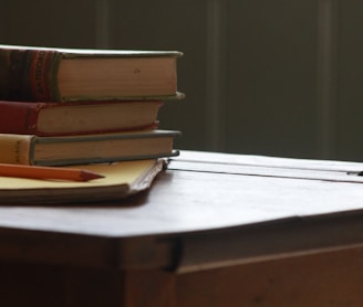 books and pencil on wooden table