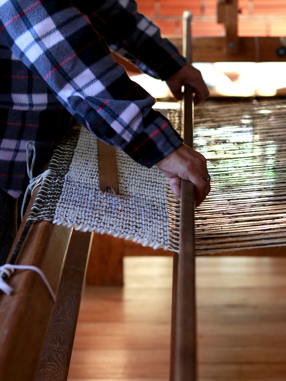 person weaving cloth