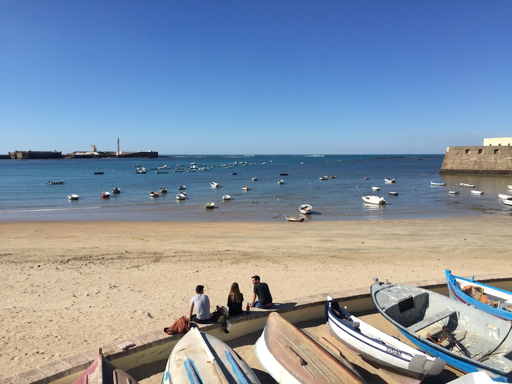 white and boats and people on shore