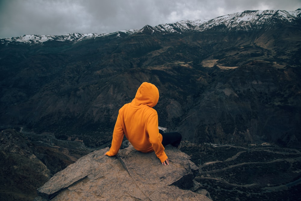 person sitting on rock