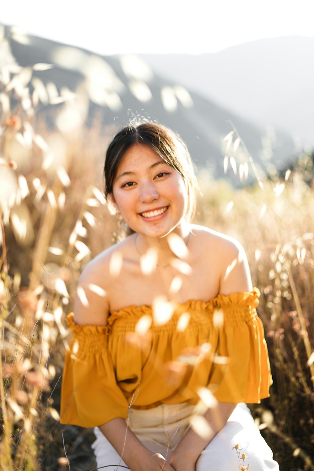 woman in yellow off shoulder shirt