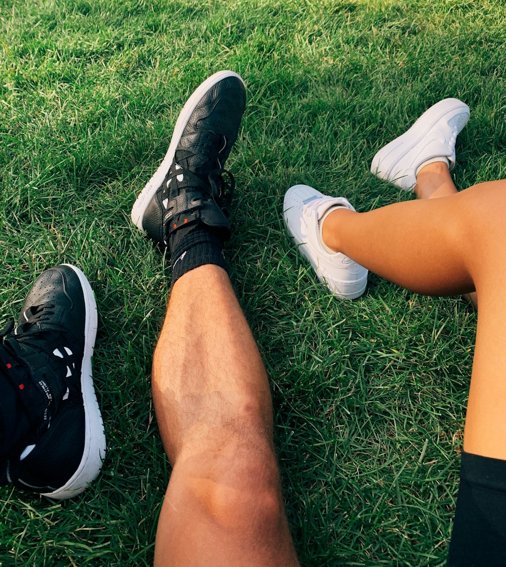 two people wearing white and black sneskers