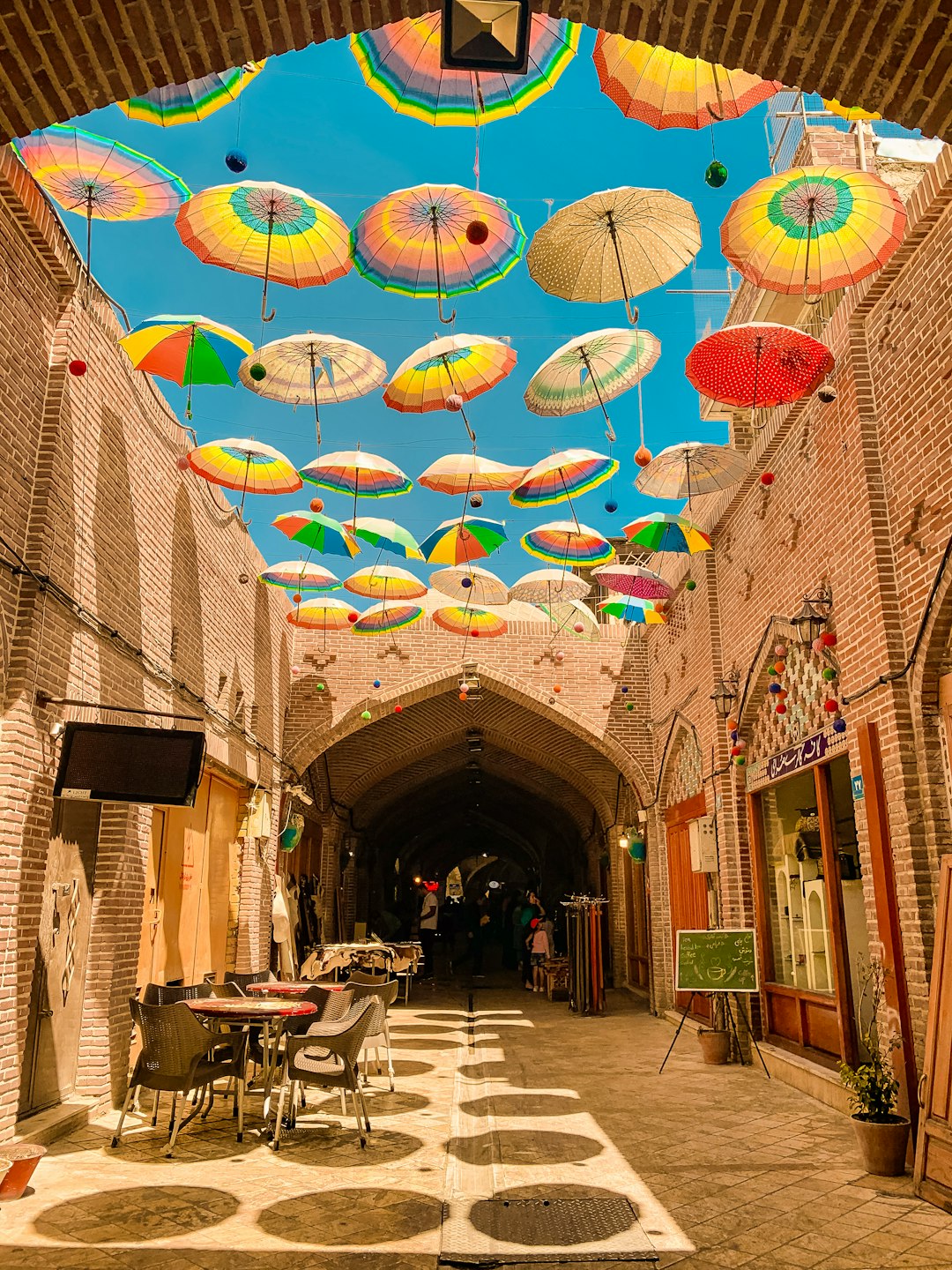 assorted-colored umbrellas hanging on alley