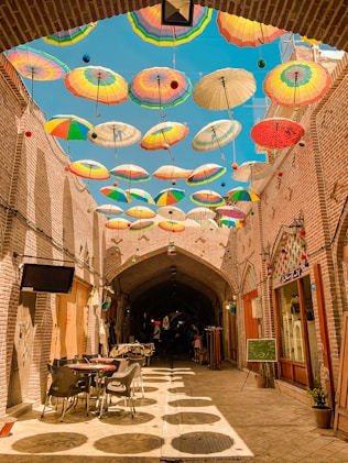 assorted-colored umbrellas hanging on alley