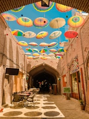 assorted-colored umbrellas hanging on alley