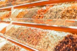 Fresh herbs and spices arranged around handcrafted seasoning jars with earthy labels.