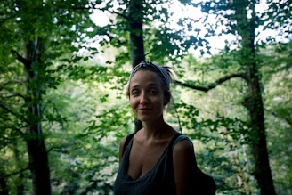 Women practicing self-defense techniques outdoors in a lush forest near Fontainebleau.