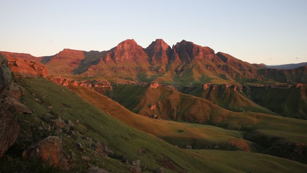 brown and green mountains under white sky at daytime