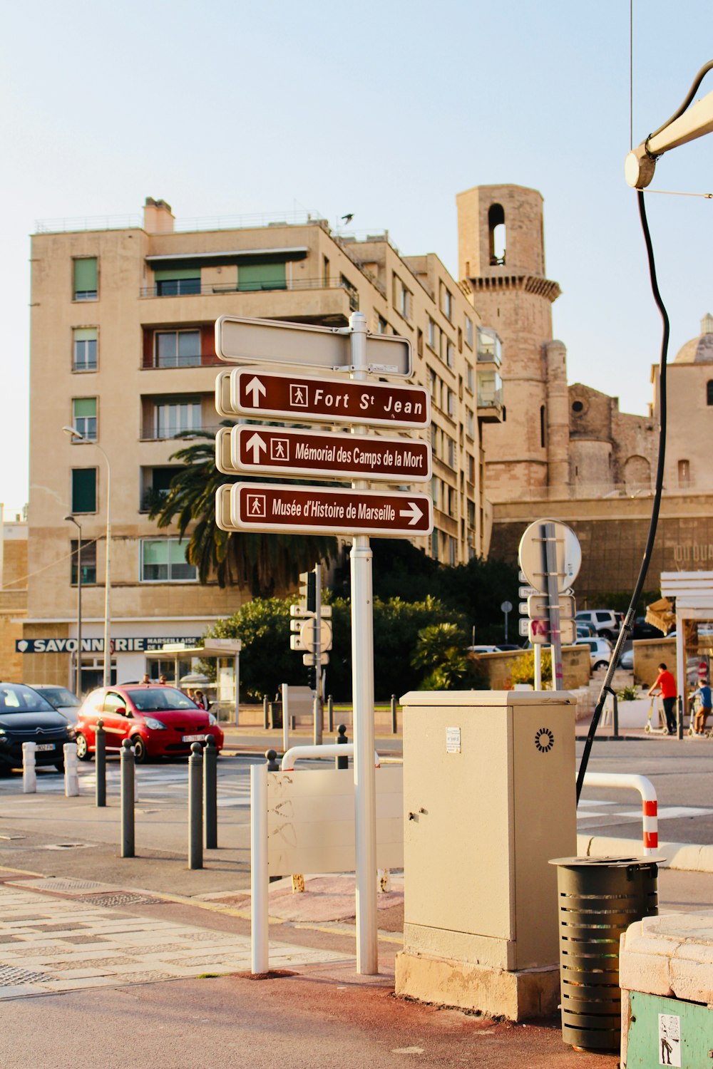 signboards on post near cars and building