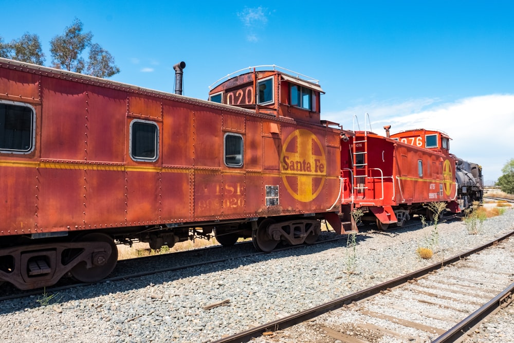 brown and orange train on railway