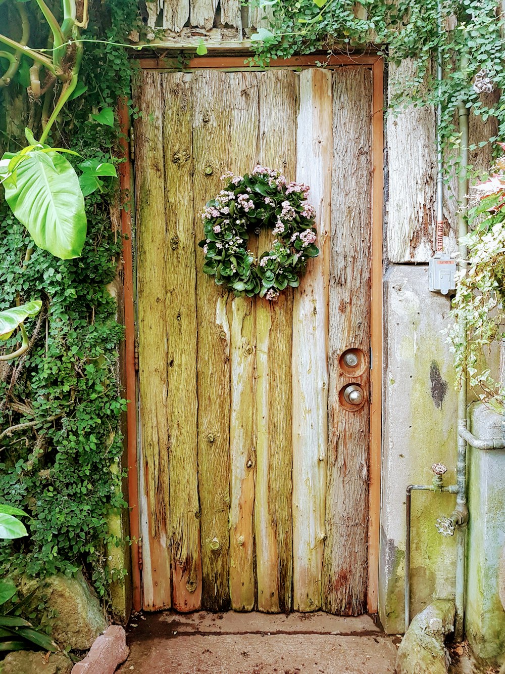 a wooden door with a wreath on it