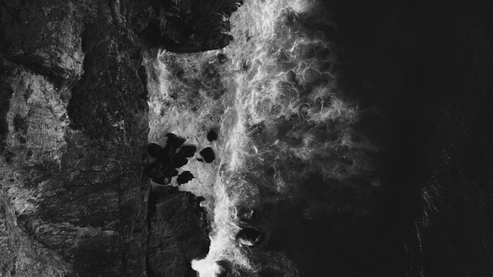 a black and white photo of a waterfall