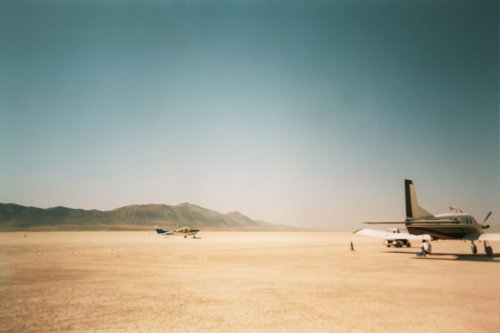 airplanes on dirt field during day