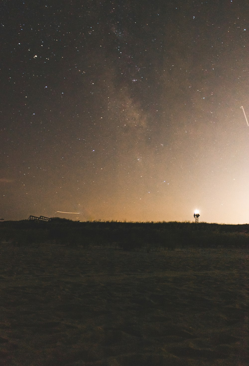 a night sky with a couple of stars in the distance