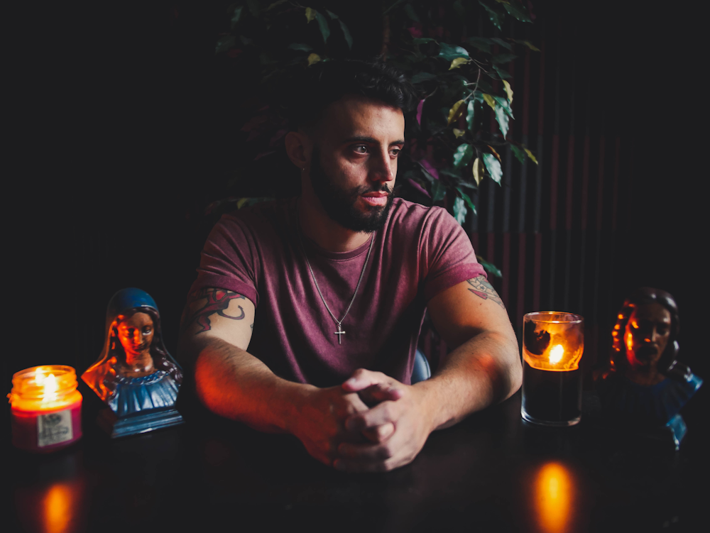 selective focus photography of sitting man clasping hands