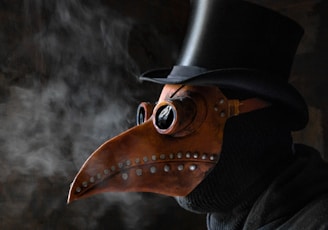 a man wearing a plague mask and a top hat