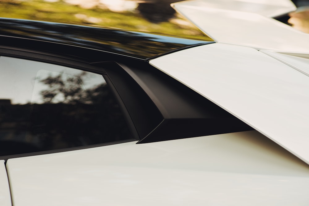 a close up of a car with a surfboard on the roof