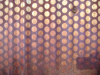 Close-up of a metal surface showing a uniform black oxide coating.