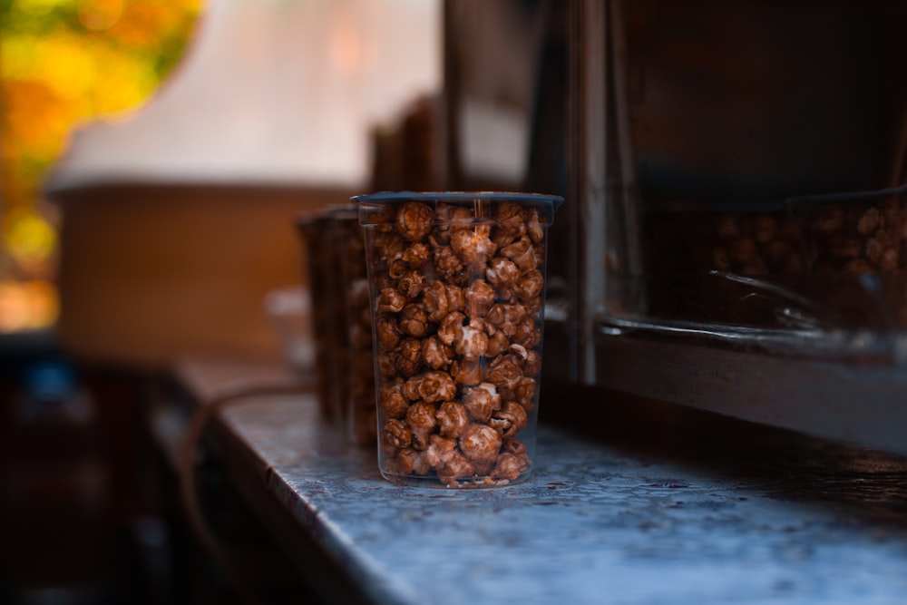 brown caramel popcorn in plastic cups