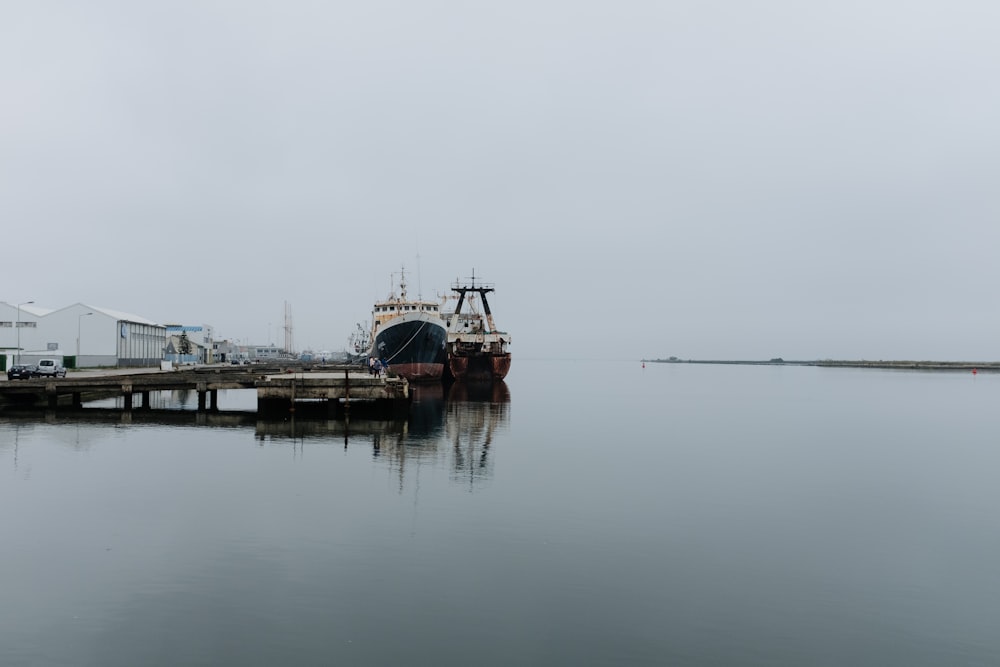 ships on dock during cloudy daytime
