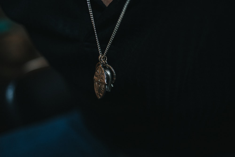 gold-colored pendant necklace