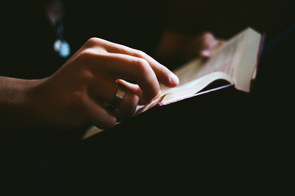 a person reading a book in the dark