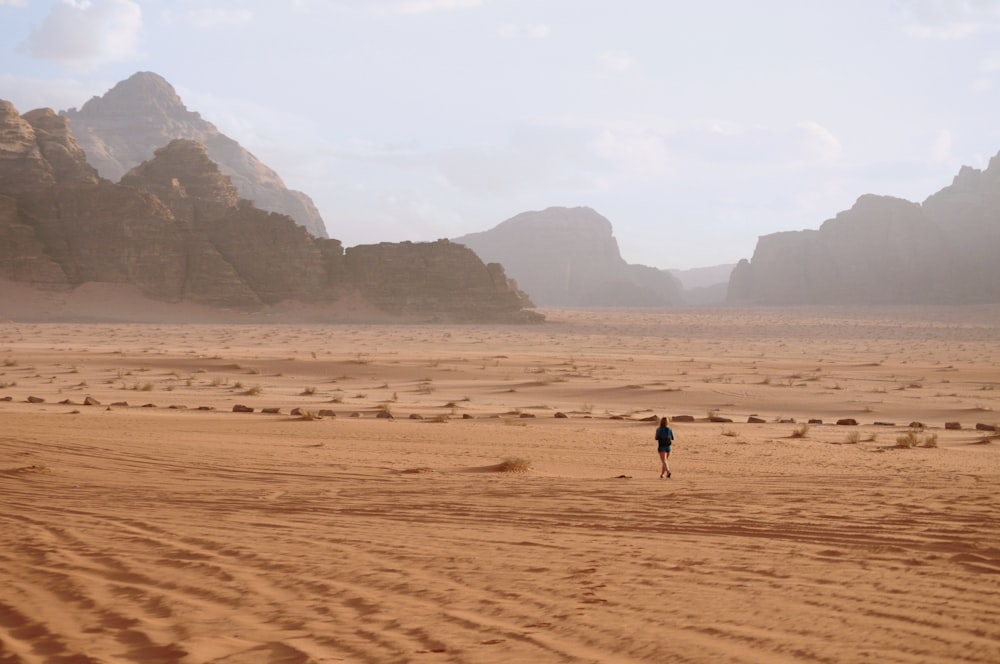 person in black at a desert
