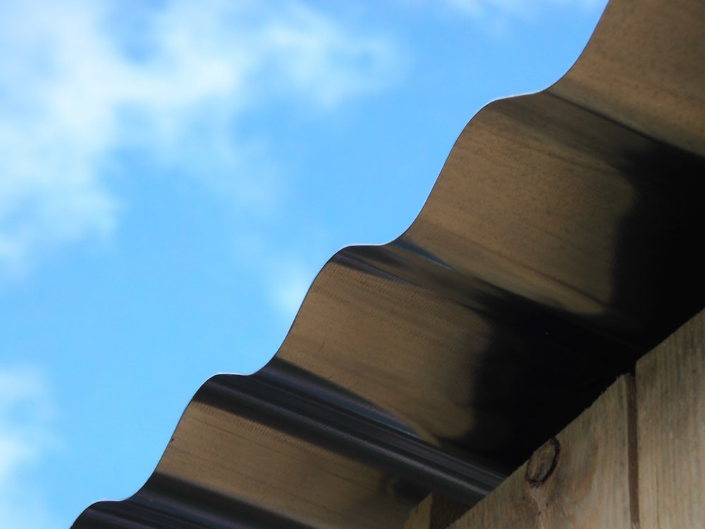 a close up of a roof with a blue sky in the background