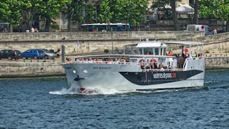 A group of happy tourists boarding a comfortable shuttle in front of a Parisian landmark.