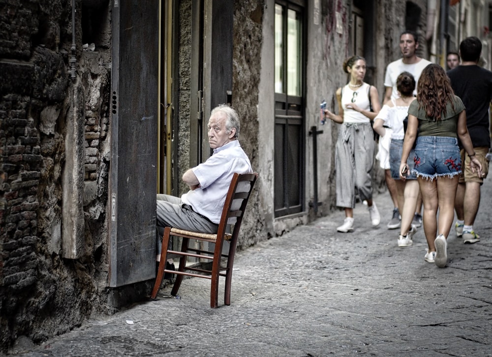 man sitting on chair on doorway