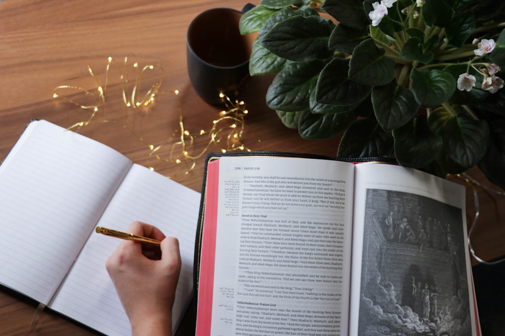 person writing on notebook