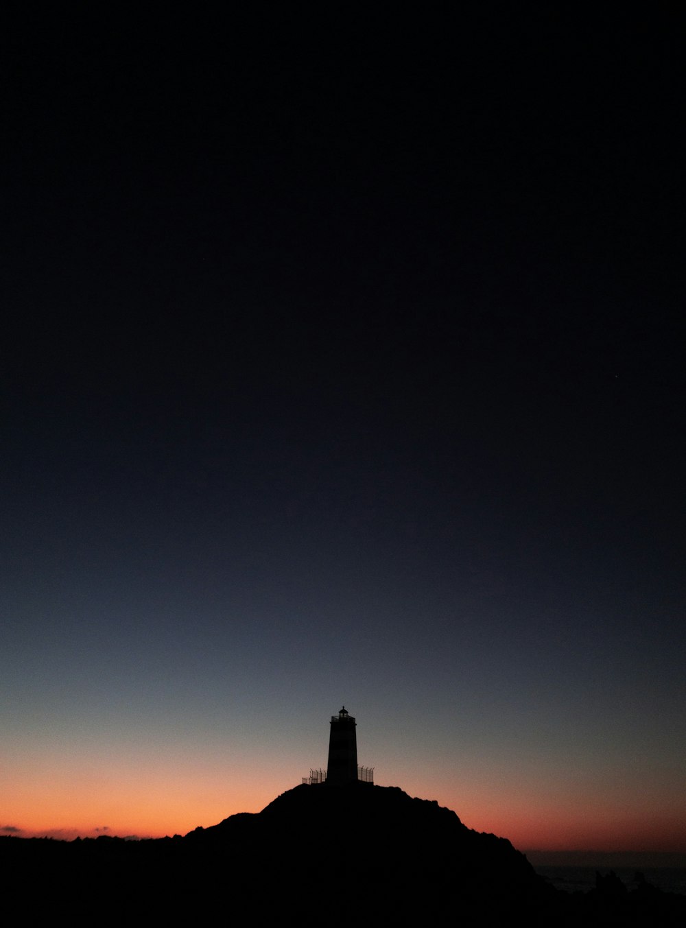 silhouette photography of lighthouse