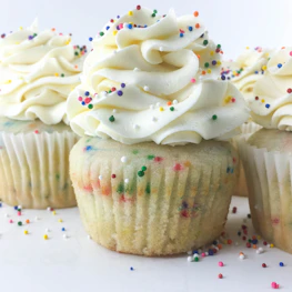 three cupcakes with toppings