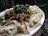 A close-up of a vibrant plate with loaded chips and noodles, ready to eat.