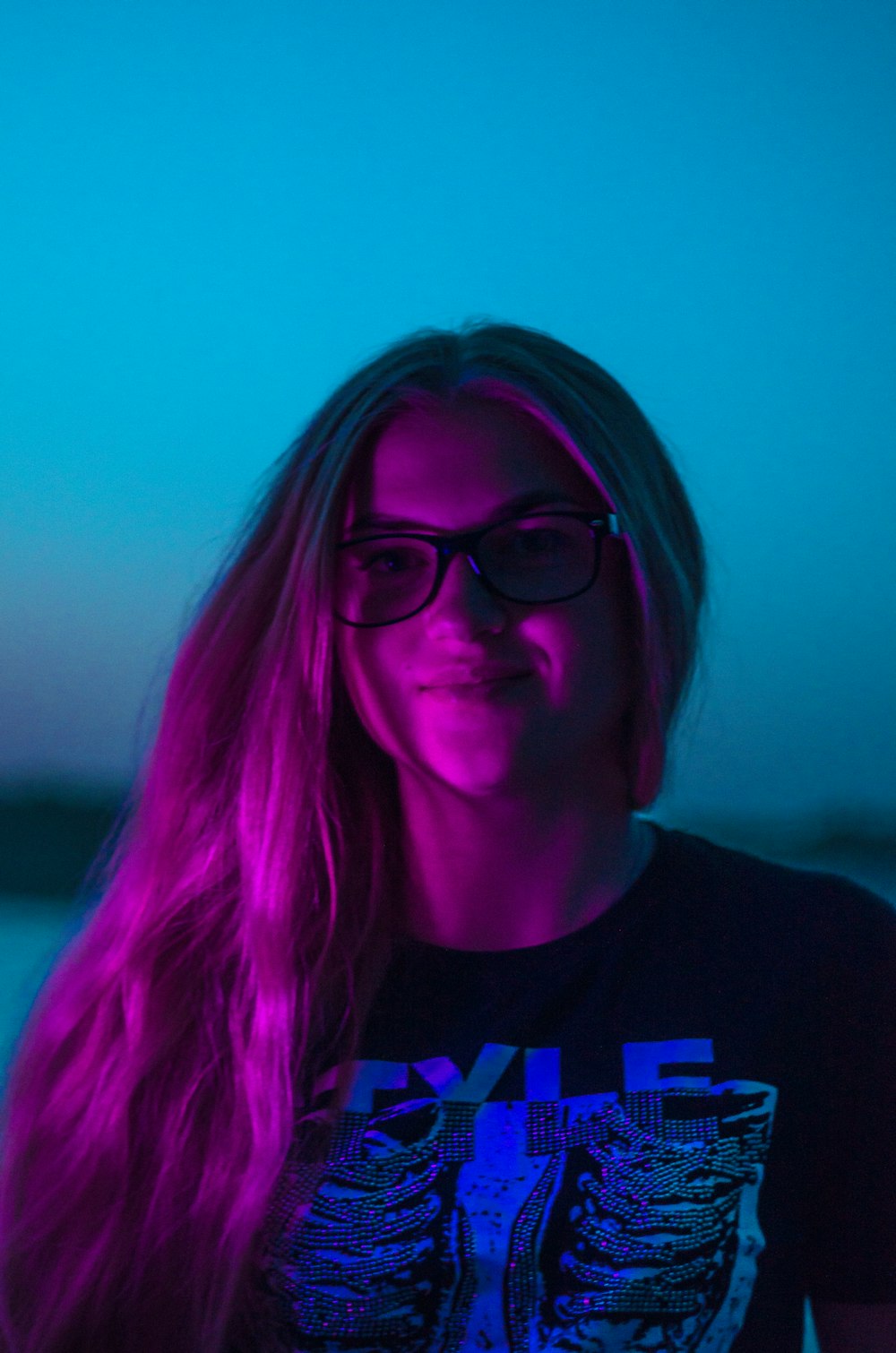 shallow focus photo of woman in black crew-neck shirt wearing eyeglasses