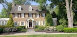 brown bricked 2-story house during daytime
