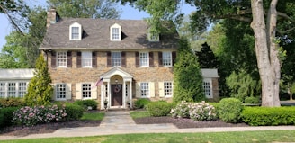 brown bricked 2-story house during daytime