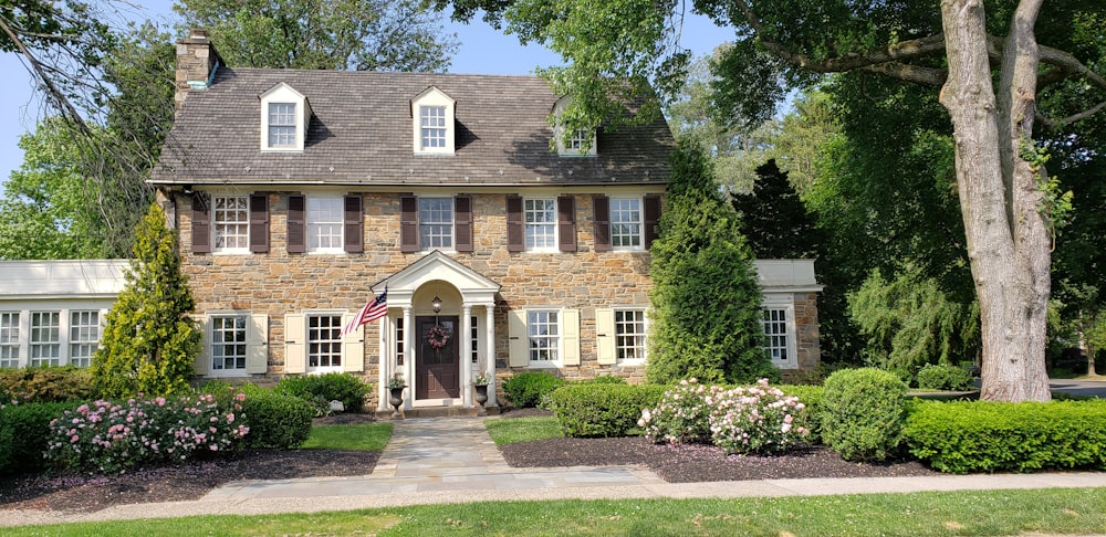 brown bricked 2-story house during daytime