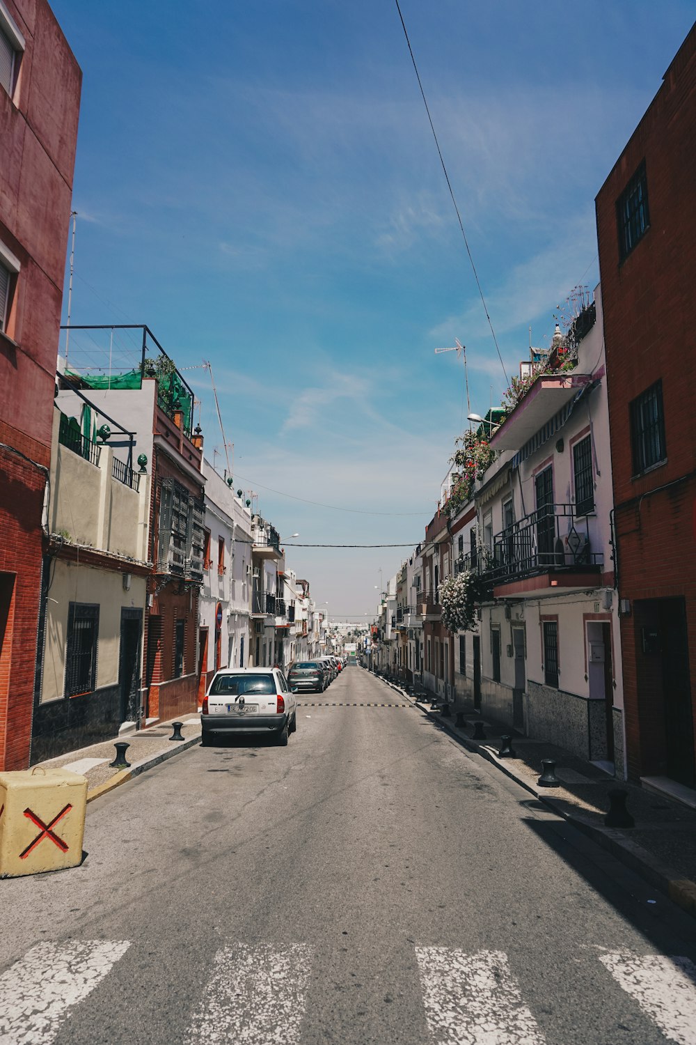 cars parked at roadside by buildings during daytime